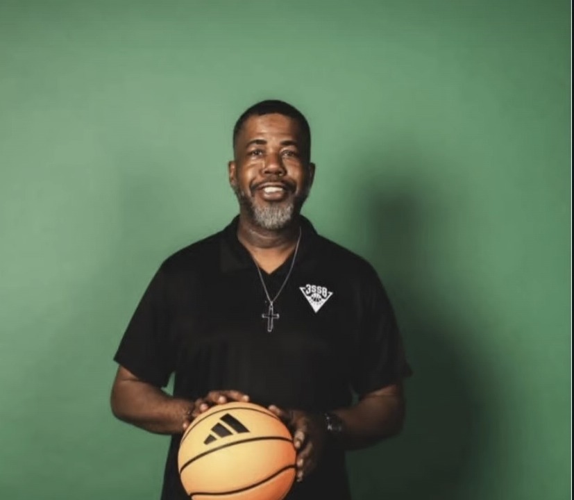 Coach Harris holding a basketball